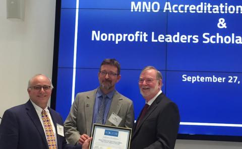 Stuart C. Mendel, Ph.D. presents NACC accreditation to MNO Program Chair Robert L. Fischer, Ph.D., and Dean Grover C. Gilmore, Ph.D.