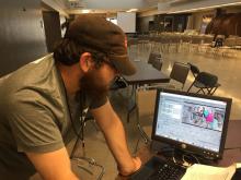 7/22/18 Kevin Smith editing the official Cleveland GiveCamp 2018 video. Note that the photo on the screen is of the Social Media Team with Kevin Smith and Stuart Smith.