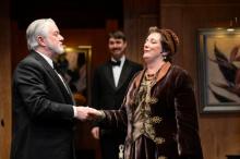Actor Laurie Birmingham (as Madame Arcati) confronts her charming skeptic Aled Davies (as Dr. Bradman) as Eric Damon Smith (center, as Charles) observes
